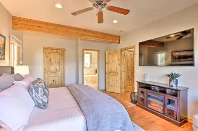 a bedroom with a bed and a fireplace at 6 Mi to Keystone Ski! Mtn-View Cabin with Game Room in Silverthorne