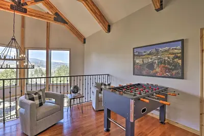 a living room with a ping pong table at 6 Mi to Keystone Ski! Mtn-View Cabin with Game Room in Silverthorne
