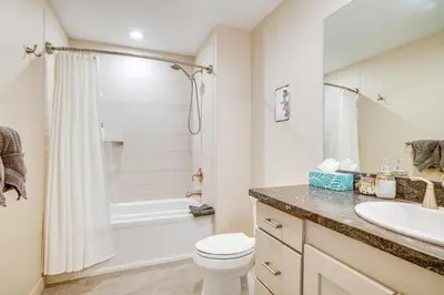 a bathroom with a toilet and a sink at Steps to Conquest Ski Lift Granby Home with Grill in Granby