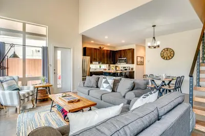 a living room with a couch and a table at Steps to Conquest Ski Lift Granby Home with Grill in Granby