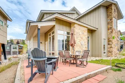 a house with a patio with a table and chairs at Steps to Conquest Ski Lift Granby Home with Grill in Granby