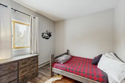 a bedroom with a bed and a window at Take the Mountain View in Silverthorne