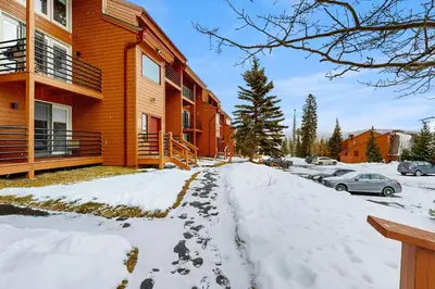 a snow covered sidewalk in front of a building at Take the Mountain View in Silverthorne