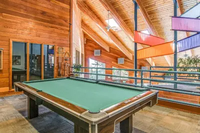 a pool table in a room with wooden walls at Take the Mountain View in Silverthorne