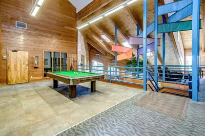 a pool table in a room with wooden walls at Take the Mountain View in Silverthorne