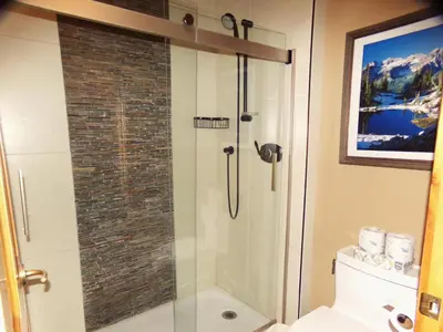 a bathroom with a shower with a glass door at Buffalo Lodge 2 Bed 2 Ba BLCD2 in Keystone