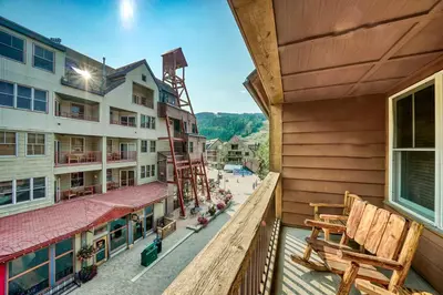 an apartment balcony with chairs and a building at Buffalo Lodge 2 Bed 2 Ba BLCD2 in Keystone