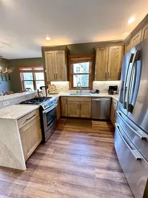 a kitchen with wooden cabinets and a stainless steel refrigerator at 2348 Red Hawk Townhomes condo in Keystone