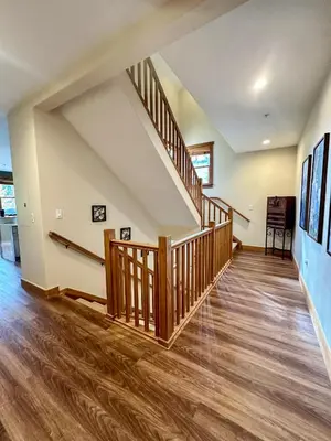 an empty living room with a staircase and wood floors at 2348 Red Hawk Townhomes condo in Keystone