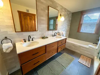 a bathroom with two sinks and a bath tub at 2348 Red Hawk Townhomes condo in Keystone