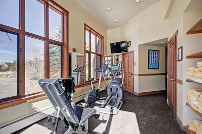 a fitness room with treadmills and exercise bikes at 2348 Red Hawk Townhomes condo in Keystone