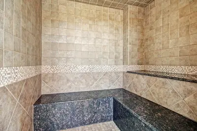 a tiled bathroom with a shower with two shelves at 2348 Red Hawk Townhomes condo in Keystone