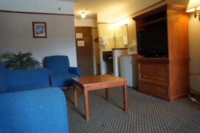 a living room with a couch and a tv and a table at Luxury Inn & Suites in Silverthorne