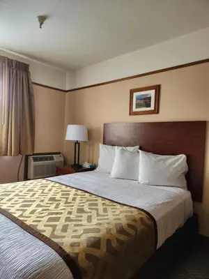 a hotel room with a large bed and a window at Luxury Inn & Suites in Silverthorne