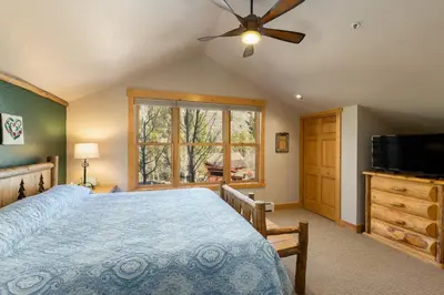 a bedroom with a bed and a flat screen tv at 8767 Trappers Crossing condo in Keystone