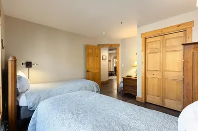 a bedroom with two beds and a closet at 8767 Trappers Crossing condo in Keystone