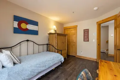 a bedroom with a bed and a table at 8767 Trappers Crossing condo in Keystone