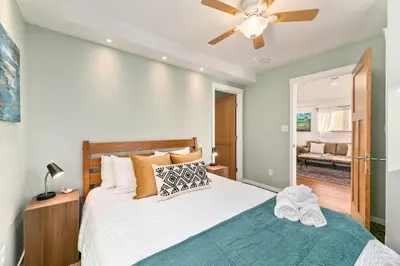 a bedroom with a bed and a ceiling fan at Vibrant Downtown Bungalow - Walk Everywhere! in Fort Collins