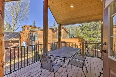 a patio with a table and chairs on a deck at 6 Mi to Slopes! Mtn-View Breck Gem with Resort Perks in Breckenridge