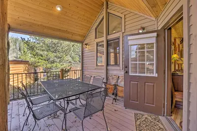a patio with a table and chairs on a deck at 6 Mi to Slopes! Mtn-View Breck Gem with Resort Perks in Breckenridge