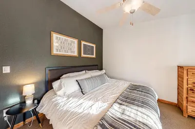 a bedroom with a bed and a ceiling fan at Fraser Fantasy in Fraser