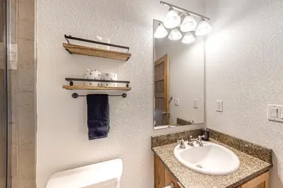 a bathroom with a sink and a mirror at Fraser Fantasy in Fraser