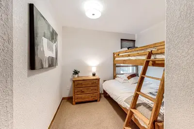 a bedroom with a bunk bed and a bunk ladder at Fraser Fantasy in Fraser