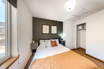 a bedroom with a large bed and a window at Fraser Fantasy in Fraser