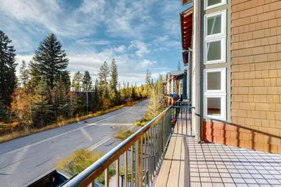 a balcony of a building with an empty street at Fraser Fantasy in Fraser