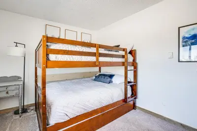a bedroom with two bunk beds in a room at Condo with Balcony and Views - Steps to Ski Shuttle! in Fraser
