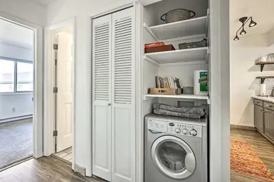 a laundry room with a washing machine in it at Condo with Balcony and Views - Steps to Ski Shuttle! in Fraser