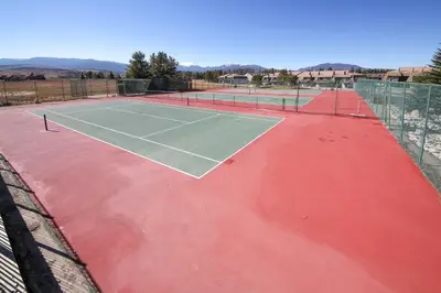 a tennis court with two tennis courts at Condo with Balcony and Views - Steps to Ski Shuttle! in Fraser