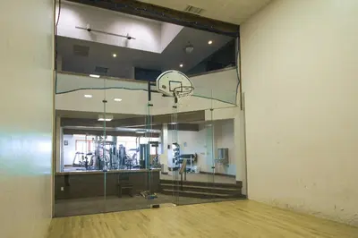 an empty gym with a basketball hoop in a room at Condo with Balcony and Views - Steps to Ski Shuttle! in Fraser