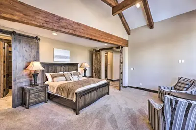 a bedroom with a large bed and a chair at 3 Fireplaces and Mtn View Luxe Home in Breckenridge in Breckenridge