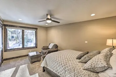 a bedroom with a bed and a ceiling fan at 3 Fireplaces and Mtn View Luxe Home in Breckenridge in Breckenridge