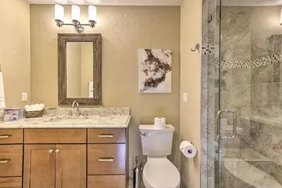 a bathroom with a toilet and a sink and a shower at 3 Fireplaces and Mtn View Luxe Home in Breckenridge in Breckenridge