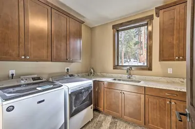 a kitchen with a washing machine and a window at 3 Fireplaces and Mtn View Luxe Home in Breckenridge in Breckenridge