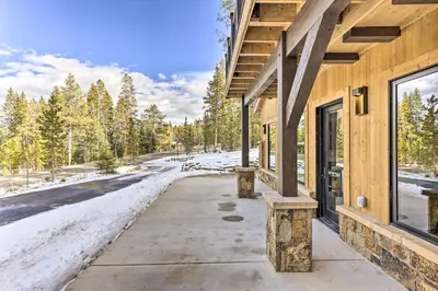 a building with snow on the ground next to a road at 3 Fireplaces and Mtn View Luxe Home in Breckenridge in Breckenridge
