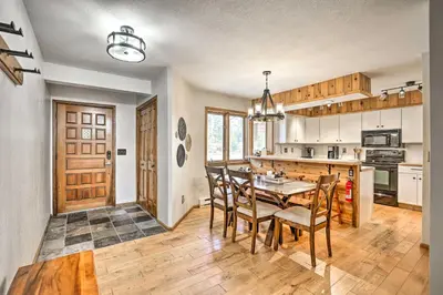 a kitchen and dining room with a table and chairs at Sunny Alpine Escape with Hot Tub and Mountain Vistas! in Fraser