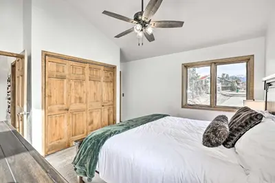 a bedroom with a bed and a ceiling fan at Sunny Alpine Escape with Hot Tub and Mountain Vistas! in Fraser