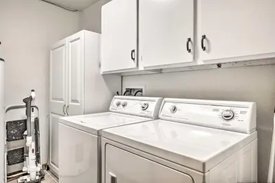 a white laundry room with a washer and dryer at Sunny Alpine Escape with Hot Tub and Mountain Vistas! in Fraser