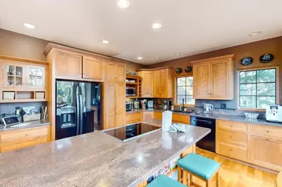 a kitchen with wooden cabinets and a large counter top at Crescent Moon Sanctuary in Silverthorne