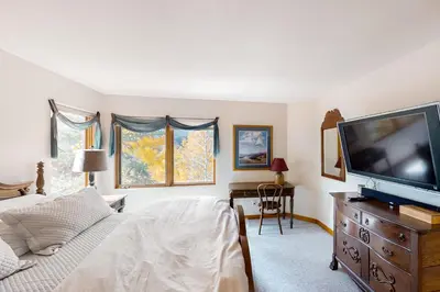 a bedroom with a flat screen tv and a bed at Crescent Moon Sanctuary in Silverthorne