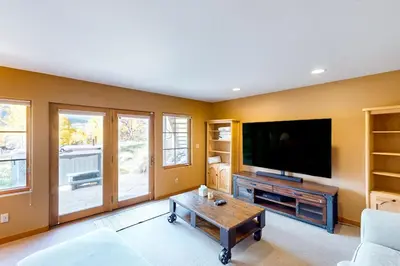 a living room with a tv and a coffee table at Crescent Moon Sanctuary in Silverthorne