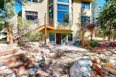 a large house with a balcony and a yard at Crescent Moon Sanctuary in Silverthorne