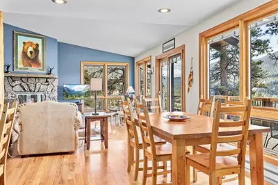 a dining room with a table and chairs at Solitude Vacation Home at Windcliff home in Estes Park
