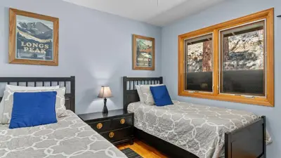 a bedroom with two beds and a window at Solitude Vacation Home at Windcliff home in Estes Park