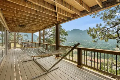 a hammock on a deck with a view at Solitude Vacation Home at Windcliff home in Estes Park
