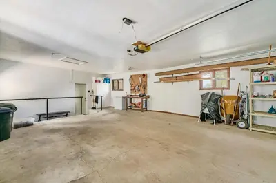 an empty garage with a large room with a ceiling fan at Solitude Vacation Home at Windcliff home in Estes Park