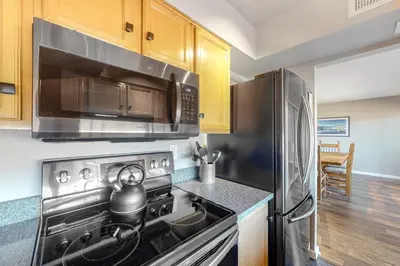 a kitchen with a stainless steel stove and microwave at Wildernest Rest in Silverthorne